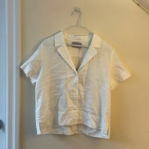White, button down, short sleeved, Everlane shirt.